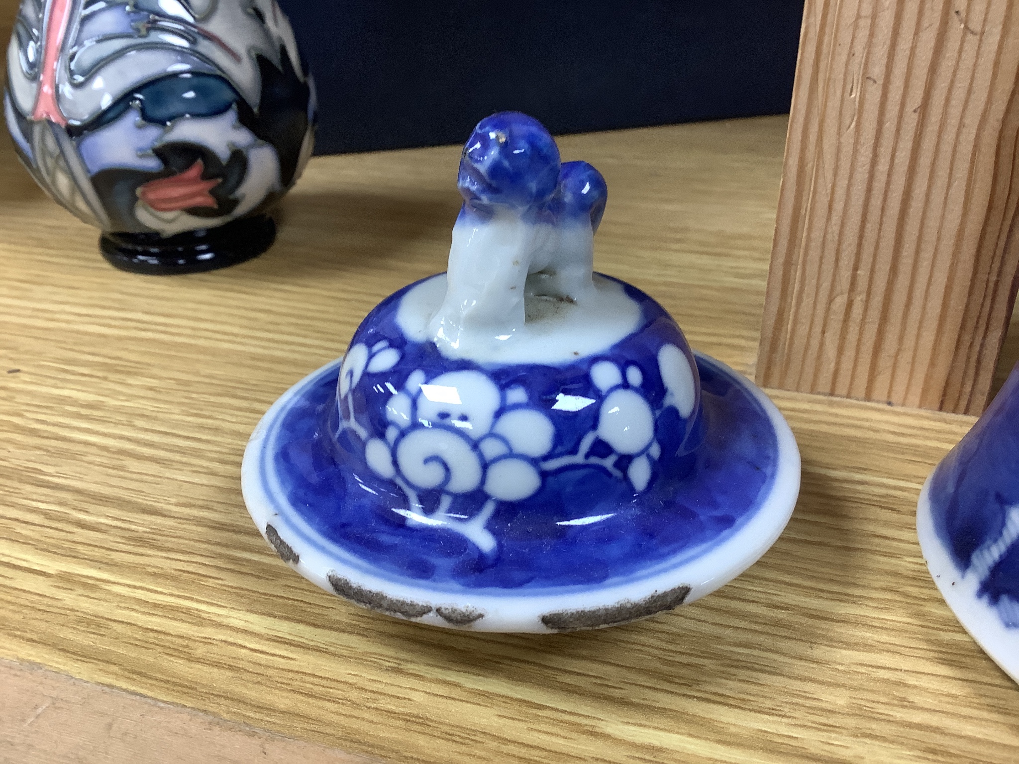 A pair of early 20th century Chinese blue and white prunus vases and covers, height 30cm